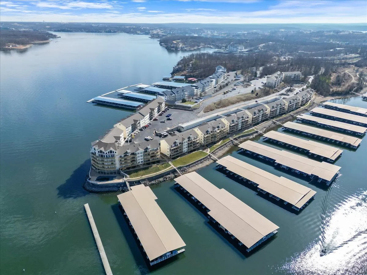 A peaceful waterfront scene with marina, boats, and surrounding landscape. The spacious area invites boating, fishing, and lakeside relaxation, embodying the spirit of lakeside adventure and community activities.